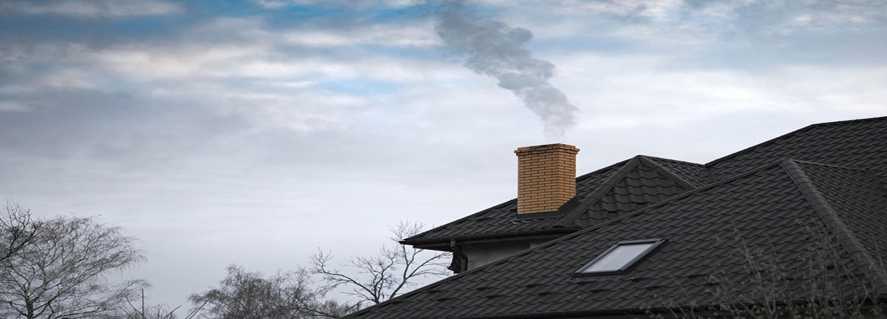 Close-up of a chimney on the roof, showcasing craftsmanship by CHIMNEY AND STONE MASONRY LLC
