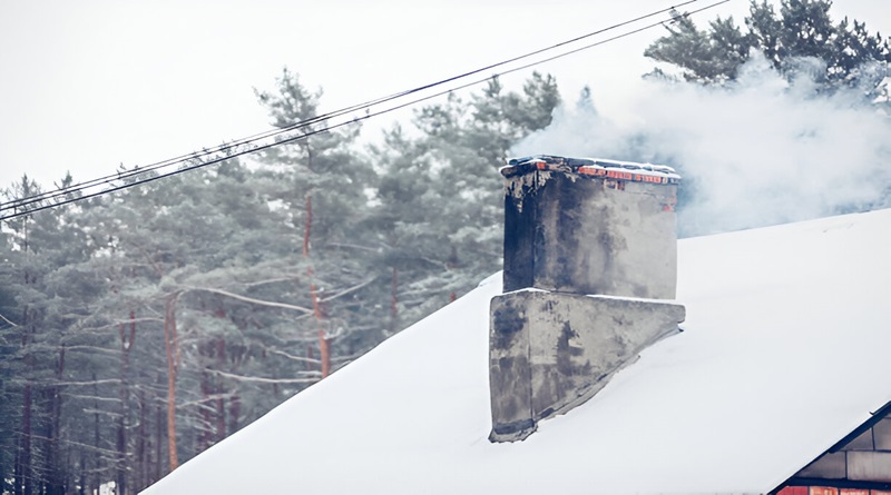 Restaurant chimney covered for winter with snow protection and smoke venting